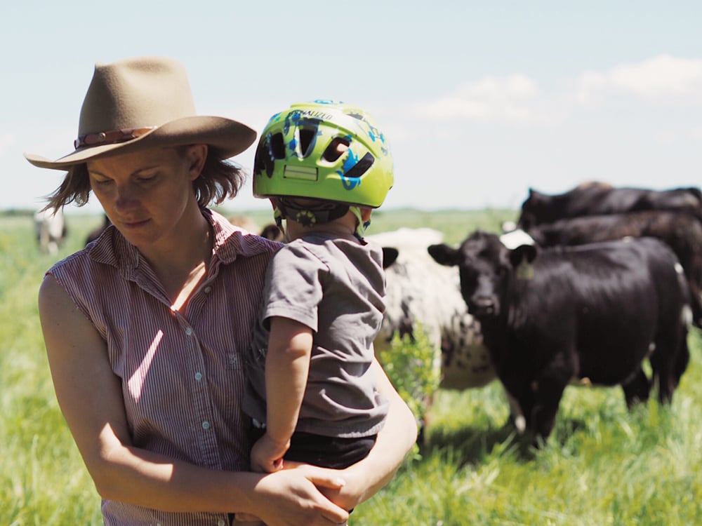 Michelle Schram, with her young son, on the farm she co-runs with husband Troy Stozek near Cartwright.