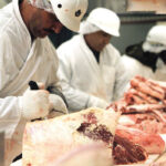 Workers bone and cut beef at a
meat-packing plant in Toronto.