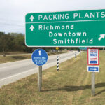 A road sign directs traffic to Smithfield Foods’ pork-processing facilities in Smithfield, Virginia.