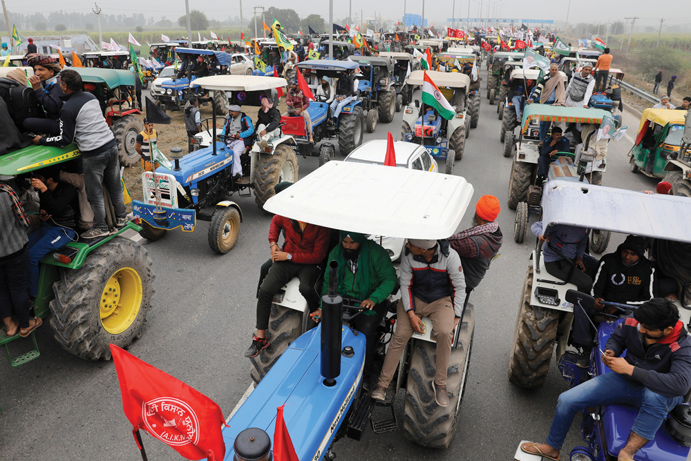Farmers participate in a tractor rally to protest against the newly passed farm bills, on a highway on the outskirts of New Delhi, India, January 7, 2021.