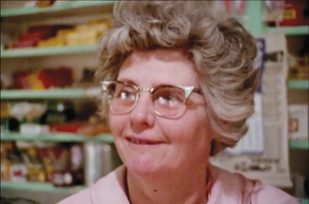 A grainy still from an old movie shows Aunt Ellen behind the counter of Havakeen Lunch.