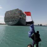 A man waves an Egyptian flag after the Ever Given, one of the world’s largest container ships, is fully floated on the Suez Canal in Egypt on March 29, 2021. (Photo: Suez Canal Authority handout via Reuters)
