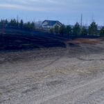 A home narrowly escapes a grassfire near Carberry April 1.