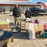 H.E.L.P. growing project members Ron Tone (left) and Gerry Lahaie (right) with donated items outside Grunthal Auction Mart.