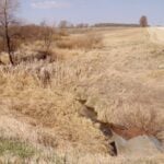 File photo of a trickling culvert in May 2021. 