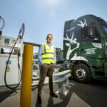 Stuart Watts, a director of Glenfiddich parent company William Grant & Sons, stands by a fuelling station next to their truck, that runs on whiskey-by-product based biogas, in Dufftown, Scotland.