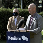 Manitoba Beef Producers president Tyler Fulton speaks to media outside the Manitoba Legislature on Aug. 31, 2021, as Manitoba agriculture minister Ralph Eichler looks on.
