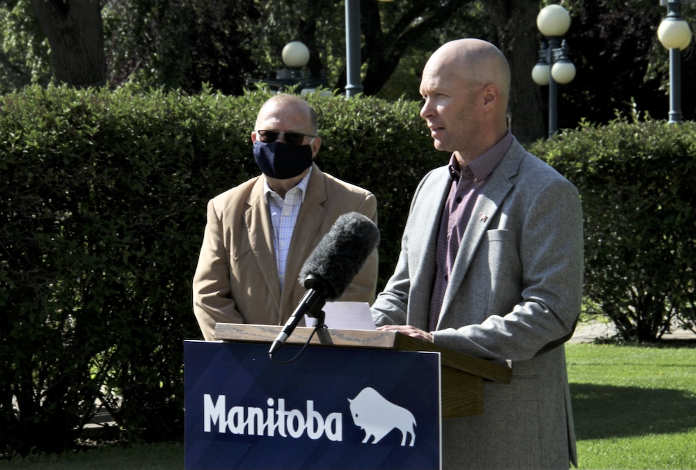 Manitoba Beef Producers president Tyler Fulton speaks to media outside the Manitoba Legislature on Aug. 31, 2021, as Manitoba agriculture minister Ralph Eichler looks on.