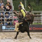 Bull riders struggled to stay aboard their full eight seconds in the arena, which had been turned to mud by a day of rain.