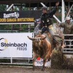Bull riders struggled to stay aboard their full eight seconds in the arena, which had been turned to mud by a day of rain.