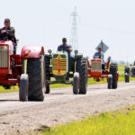 A previous year’s Tractor Trek makes its way through the countryside near Steinbach.
