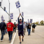 UAW picketers march across the street outside of Deere & Co., makers of John Deere products, in support of employees on strike on Oct. 20, 2021, in Ankeny.  Photo: USA TODAY NETWORK via Reuters Connect
