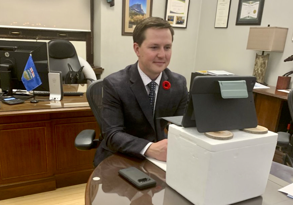 After denying he had a drinking problem, Devin Dreeshen drew more criticism for posting this picture on social media. Critics said perching his iPad on a drinks cooler wasn’t amusing and others pointed to what appears to be a wine bottle under the desk on the right-hand side of the photo. Dreeshen resigned as ag minister Nov. 5.  Photo: Twitter
