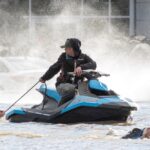 Cows that were stranded in a flooded barn at Abbotsford, B.C. are rescued on Nov. 16, 2021 by people in boats and on a jet-ski after rainstorms lashed the province, triggering landslides and floods and shutting highways. (Photo: Jennifer Gauthier/Reuters)
