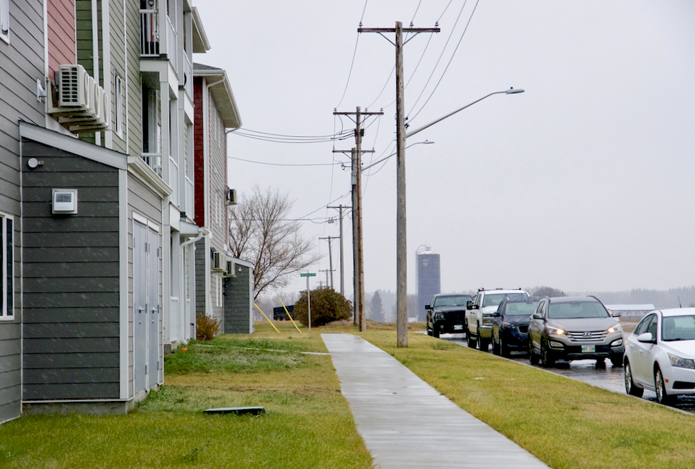 Apartments stand adjacent to farm operations outside of Brandon.