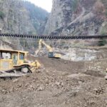 Crews work as Canadian Pacific Railway tracks are suspended above the washed-out Tank Hill underpass of the Trans-Canada Highway after devastating rain storms caused flooding and landslides, northeast of Lytton, B.C. on Nov. 20, 2021. (Photo: B.C. Ministry of Transportation and Infrastructure handout via Reuters)
