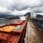 Employees working at a cargo ship at Tiplam terminal in Santos, Brazil in 2017.