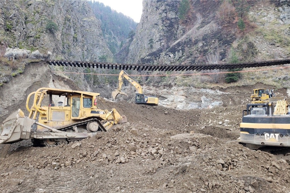 Crews work as Canadian Pacific Railway tracks are suspended above the washed-out Tank Hill underpass of the Trans-Canada Highway after devastating rain storms caused flooding and landslides, northeast of Lytton, B.C. on Nov. 20, 2021. (Photo: B.C. Ministry of Transportation and Infrastructure handout via Reuters)
