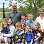 Gordon and Val Turner pose with their seven grandchildren.