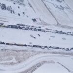 A supplied aerial photo of vehicles blocking through traffic on Feb. 1, 2022 at the Canada-U.S. border crossing between Coutts, Alta. and Sweet Grass, Montana. (Photo courtesy Alberta RCMP)