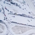 A supplied aerial photo of vehicles blocking through traffic on Feb. 1, 2022 at the Canada-U.S. border crossing between Coutts, Alta. and Sweet Grass, Montana. (Photo courtesy Alberta RCMP)