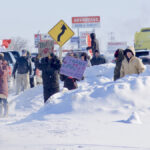 Supporters stand along the sides of the Trans-Canada Highway as the protest convoy passes Brandon, Jan. 25.