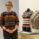 Grunthal artisan Karen Enns stands with items of clothing she made at the One Year One Outfit exhibit on February 25.