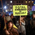 A woman holds a sign during a protest against Russia's invasion of Ukraine, at Trafalgar Square in London, Mar. 4, 2022.
