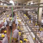 Workers in the JBS beef plant at Brooks, Alta. appear in a screen shot from a 2018 corporate video. (JBS Canada video screengrab via YouTube)

