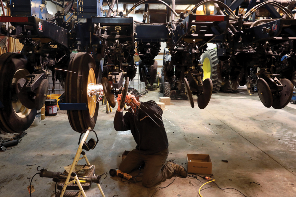 Soybean grower Austin Rincker installs high-speed planting conversion components on a planter at Moweaqua, Illinois on March 6, 2019.