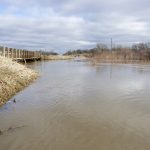 The backed-up Boyne River rushes just below bridge capacity north of Roseisle May 2.