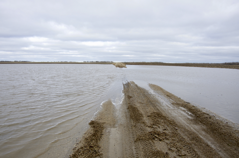 Municipal roads, such as this one in the R.M. of Thompson, went under water in the last weekend of April after the third Colorado low to hit the region in as many weeks.