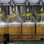 Bottles are filled with soyoil made from U.S. beans on a production line at Liangyou Industry and Trade Co. Ltd. in Qufu, China on July 4, 2018. Some traders are predicting soyoil futures may soon rise above the 90-U.S.-cents-per-pound mark.