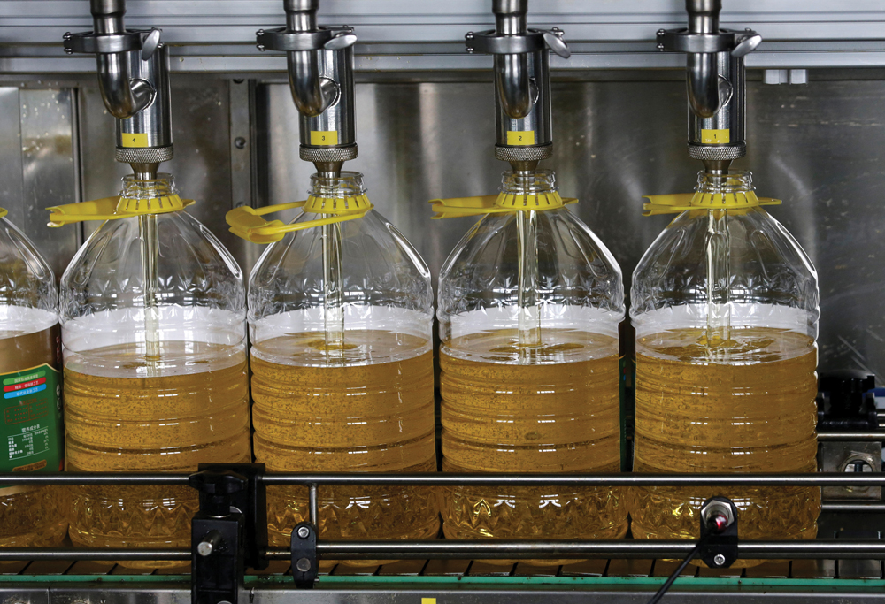 Bottles are filled with soyoil made from U.S. beans on a production line at Liangyou Industry and Trade Co. Ltd. in Qufu, China on July 4, 2018. Some traders are predicting soyoil futures may soon rise above the 90-U.S.-cents-per-pound mark.