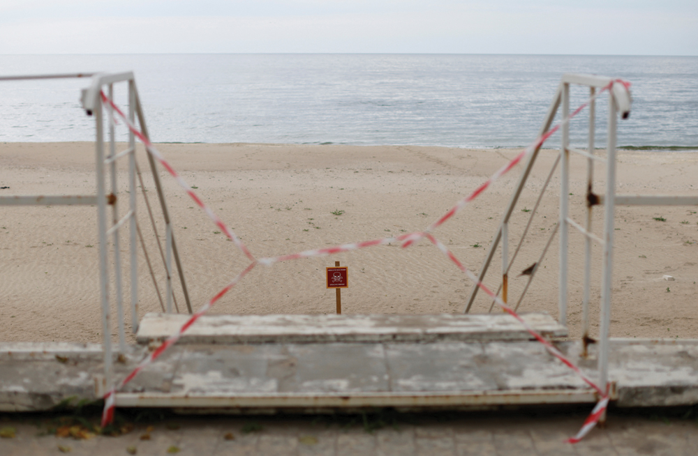 A sign warns people of mines at a closed-off beach at Odesa, Ukraine on June 6. Even if an agreement can be reached to resume grain exports via the Black Sea, it’s believed it could take months to clear mines in the waters around Ukrainian ports.