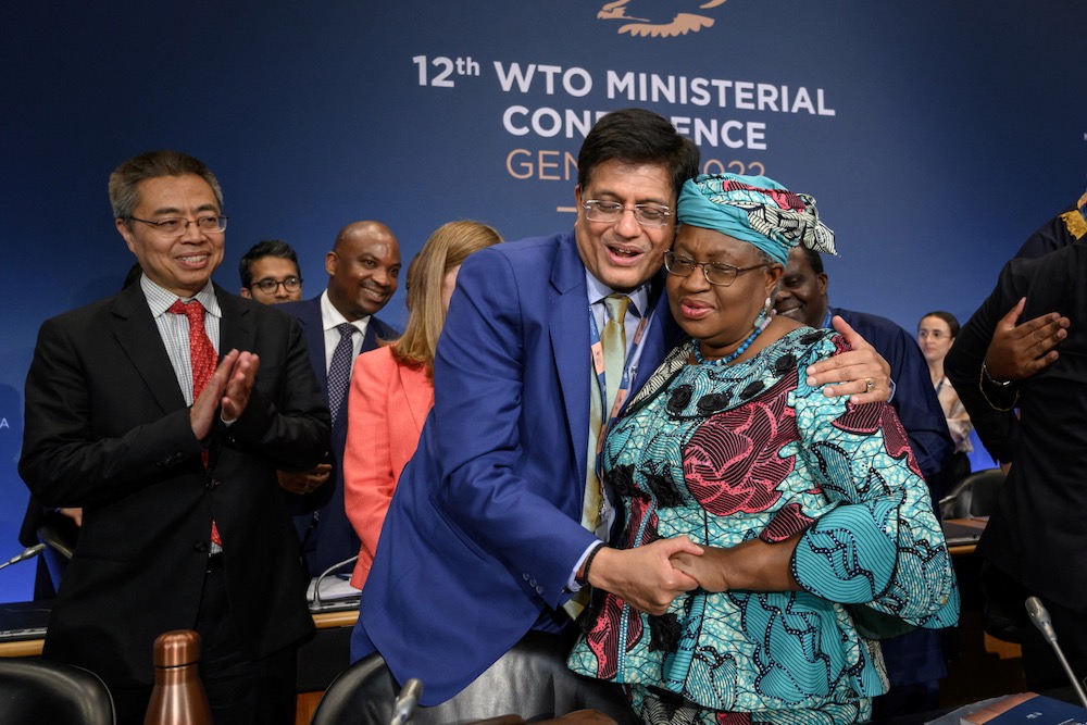 WTO director-general Ngozi Okonjo-Iweala is congratulated by India’s commerce minister Piyush Goyal after the June 17, 2022 closing session of a WTO ministerial conference in Geneva. (Photo: Fabrice Coffrini/Pool via Reuters)
