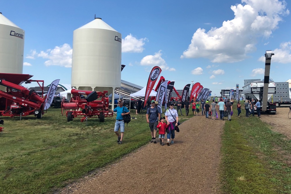 Visitors walk the grounds at Ag in Motion on July 19, 2022 after taking cover from a rain shower. (Liam O’Connor photo)
