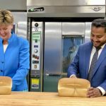 Agriculture and Agri-Food Minister Marie-Claude Bibeau and Cereals Canada CEO Dean Dias forego the customary ribbon cutting for a bread cutting ceremony to celebrate 50 years of Cereals Canada.