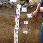 Jim Warren, a soil scientist with the Ontario Ministry of Agriculture, Food and Rural Affairs, delineates the earth’s upper soil layers in a pit during the Harnessing the Power of Soil Health at the Grand River Raceway event where Senator Rob Black announced the national soil health study launching in the fall.