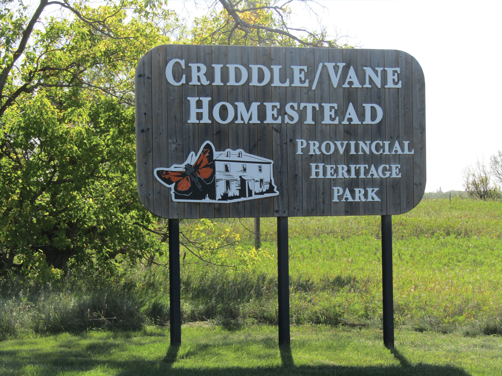 A sign marks the entrance to the homestead.