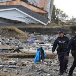 RCMP officers near a building destroyed by Hurricane Fiona at Port aux Basques, N.L. on Sept. 26, 2022. (Photo: Reuters/John Morris)