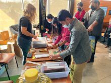 Attendees of the Discover the Farm event crushing canola to create oil.