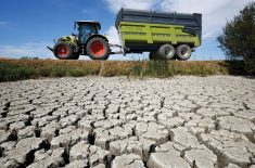 A farmer drives his tractor near cracked and dry earth at the Marais Breton in Villeneuve-en-Retz, as a historic drought hit France in August.