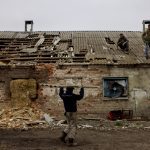 Workers repair the roof of a farm building that was damaged by a mortar, in the village of Malaya Rohan, as Russia's attack on Ukraine continues, in the Kharkiv region, Ukraine, April 9, 2022.