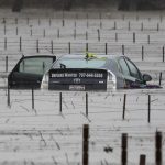 A submerged and abandoned car is seen in floodwaters near a vineyard after winter storms at Forestville, California on Jan. 13, 2023. (Photo: Reuters/Fred Greaves)
