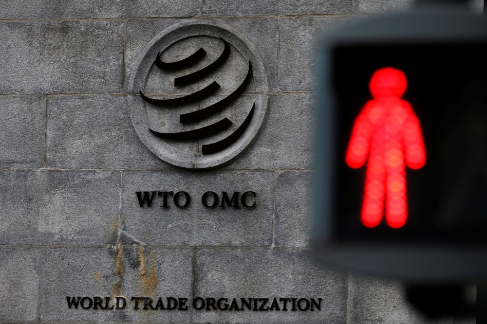 File photo of a pedestrian crossing in front of the World Trade Organization headquarters in Geneva, Switzerland on Dec. 9, 2019. (Photo: Reuters/Denis Balibouse)
