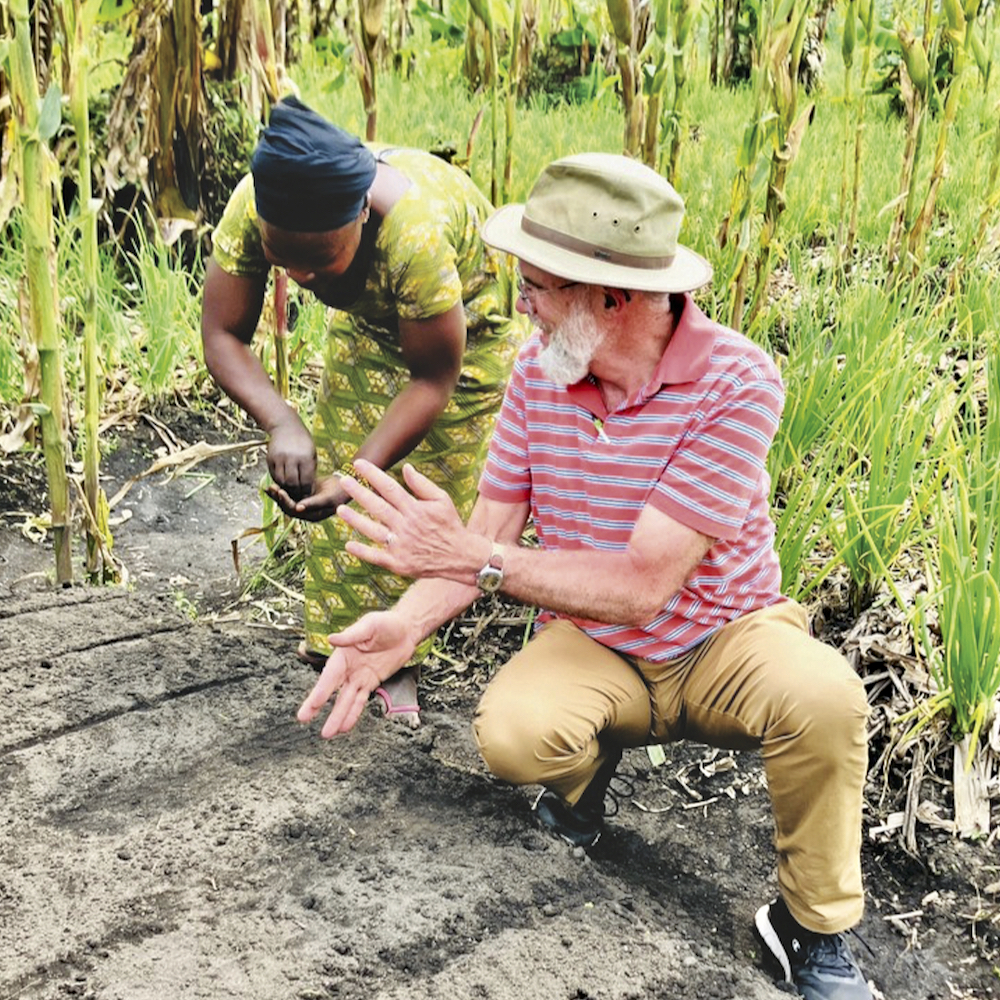 Paul Hagerman plants seeds with a farmer in Shasha, Congo.