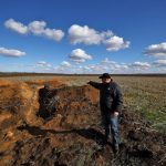Grain farmer Oleksandr Klepach points at trenches in his field, amid Russia’s invasion of Ukraine, in Snihurivka, southeast Ukraine.