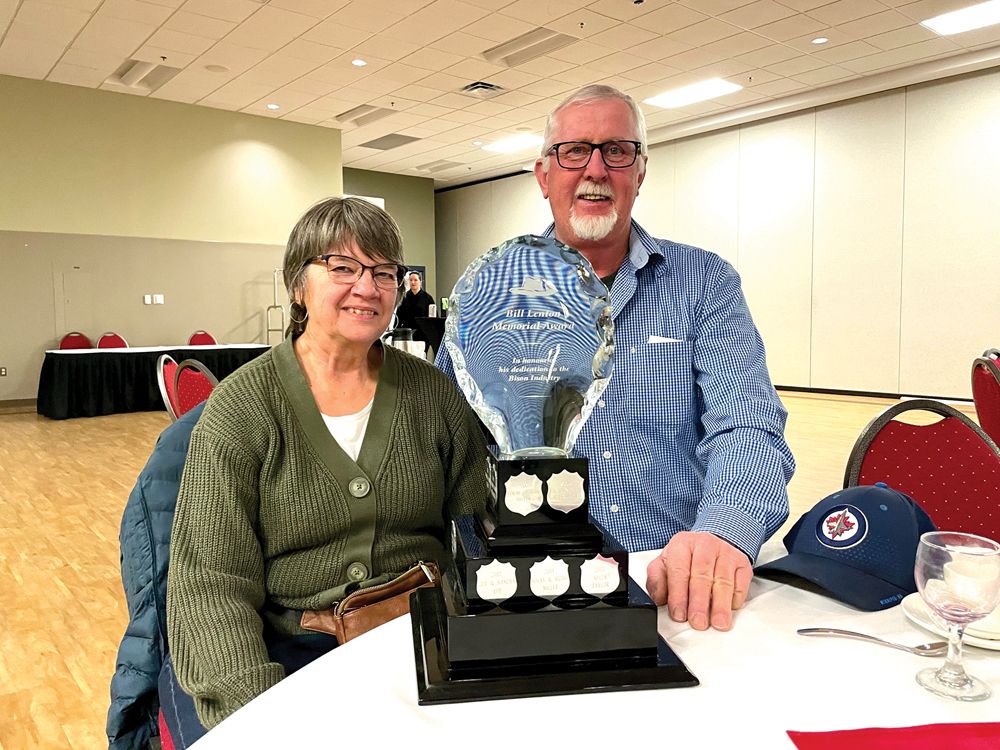 Lori and Len Koop accept the 2023 Bill Lenton Memorial Award in Brandon in February.