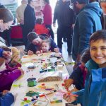 A young attendee enjoys the 4-H Council craft table.